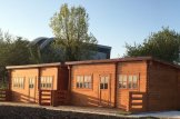 Casa in legno a tetto piatto con porticato ALTURA F S (Coibentata, 44+44 mm), 31m² + 8 m² customer 2